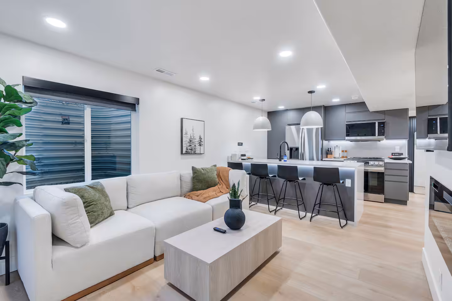 Open kitchen and bar seating connecting to the living room